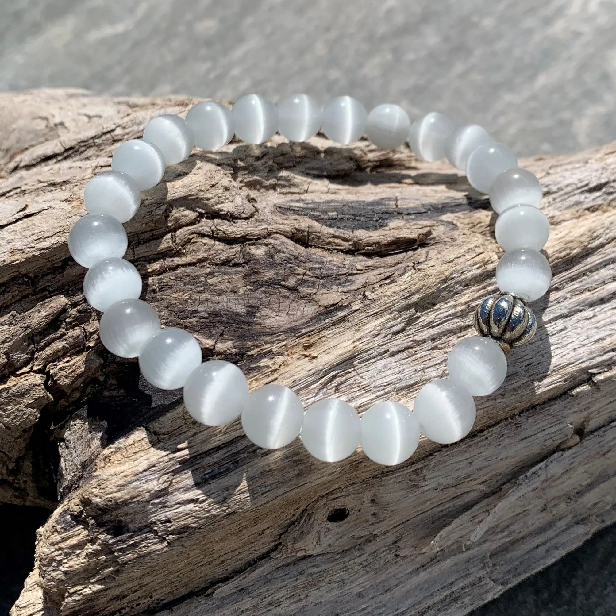 White cat's eye bracelet against the evil eye